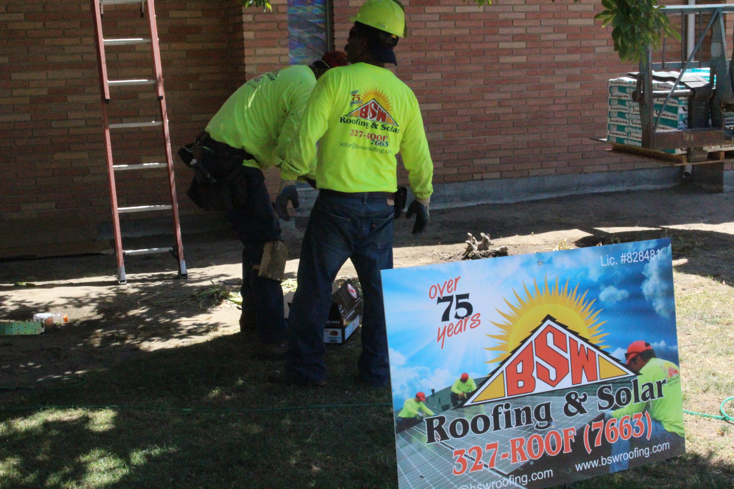 BSW crew members at a job site beside the company sign