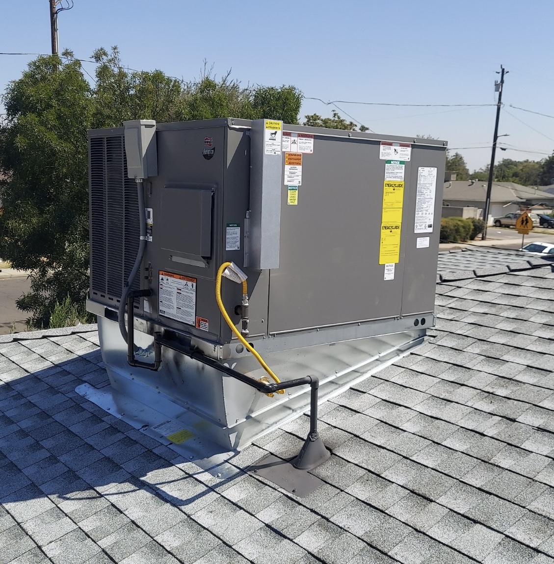 New packaged HVAC unit curbed into a shingle roof