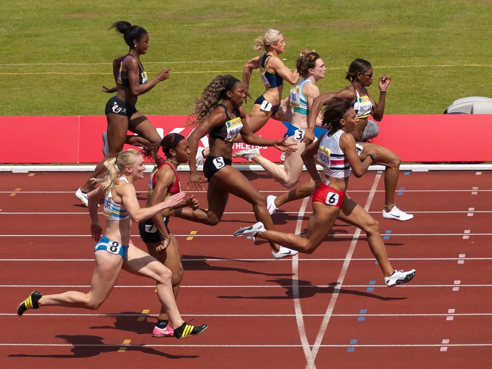 Sprinters mid-race on a track